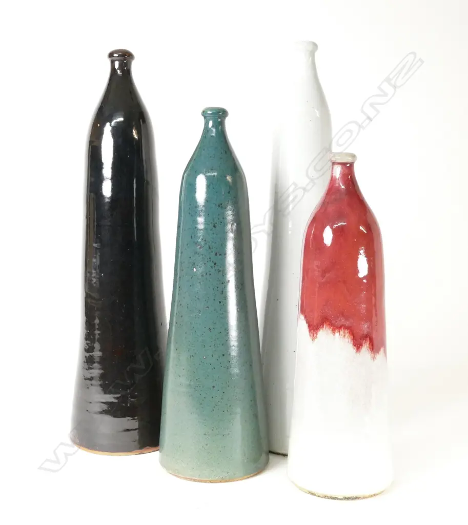 A set of four Nicholas Brandon tall bottles Image 1++