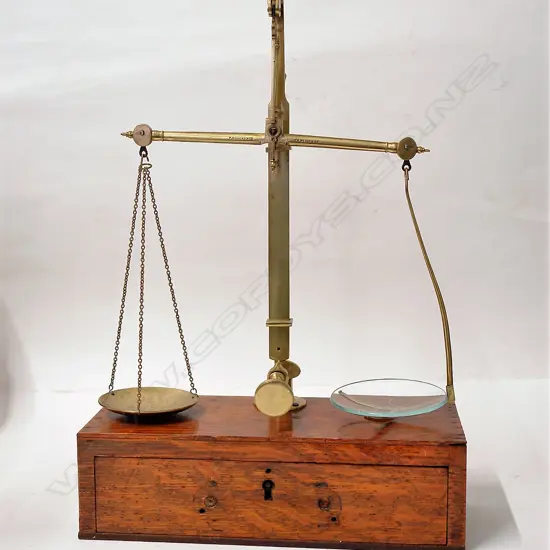 A late Victorian oak cased brass set of travelling balance scales