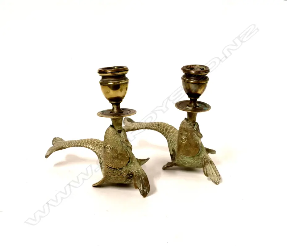 A pair of old brass fish based candlesticks Image 1++