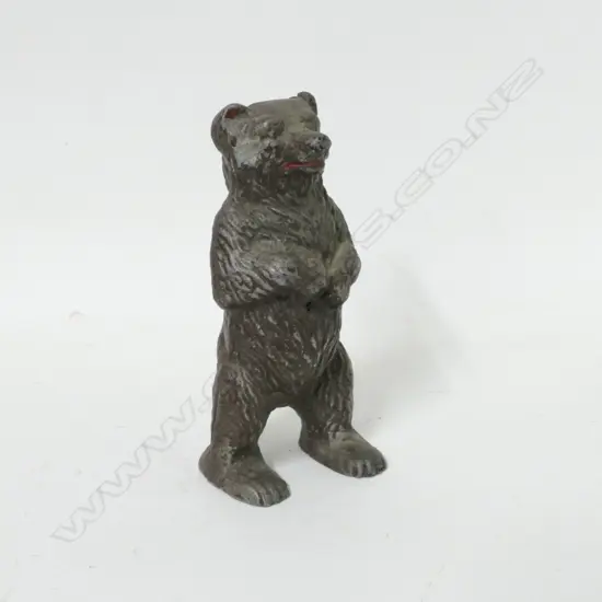 A vintage cast aluminium bear money box