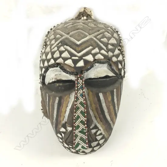 An African carved and decorated wood mask