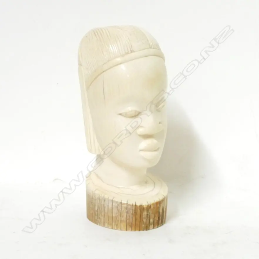 An old African carved ivory bust of a young woman Image 1++