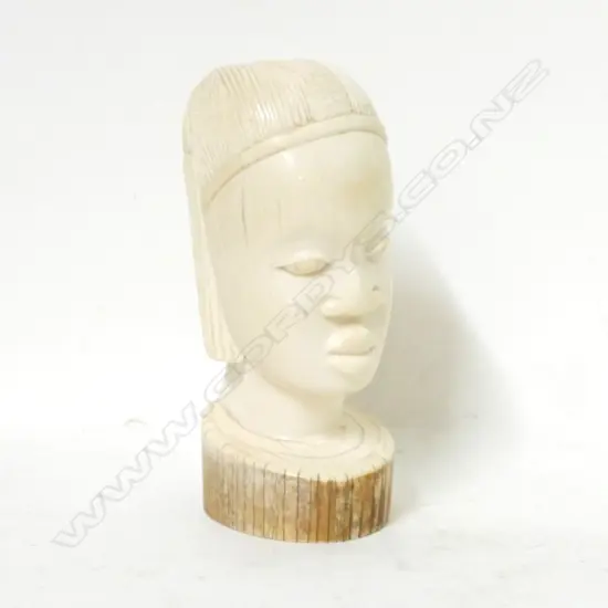 An old African carved ivory bust of a young woman