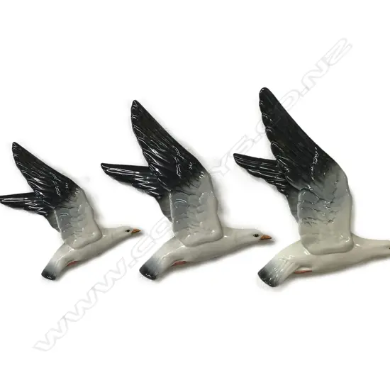 A set of three Beswick gulls in flight