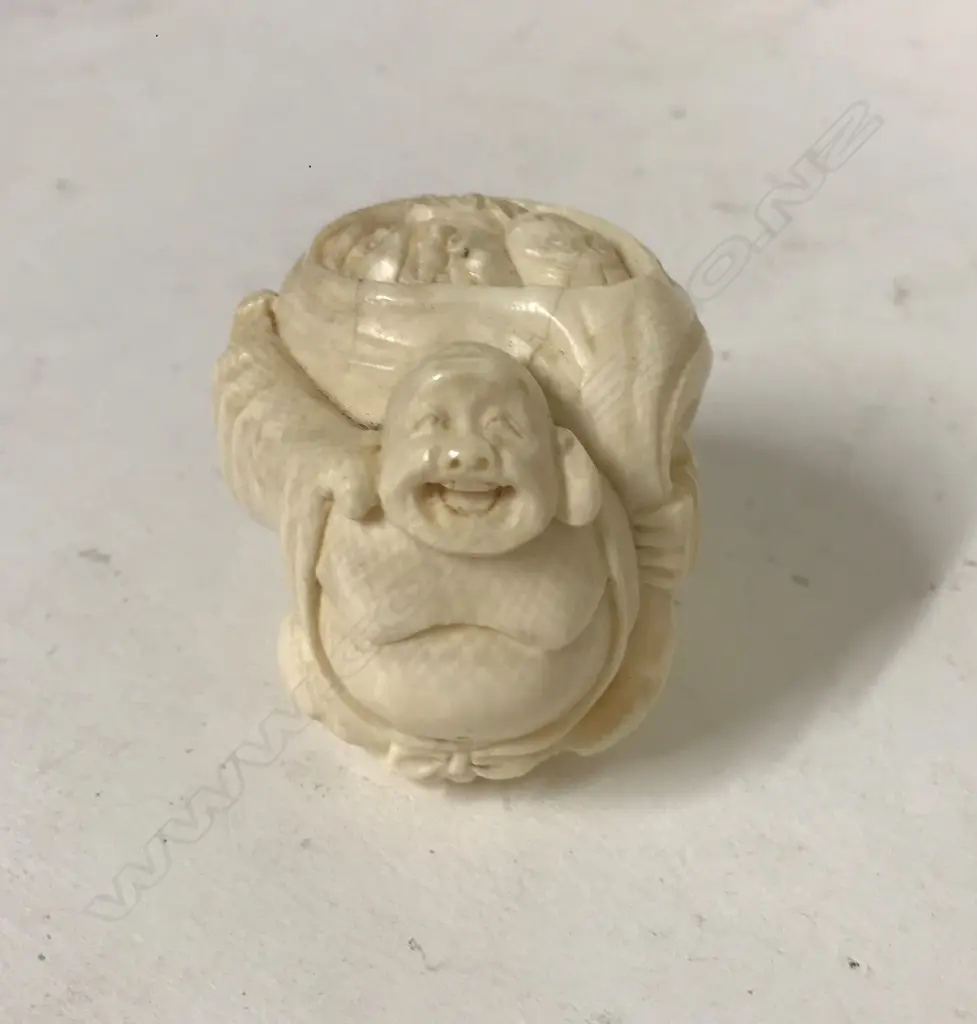 A carved figure of a Hotei Image 1++