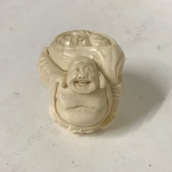 A carved figure of a Hotei