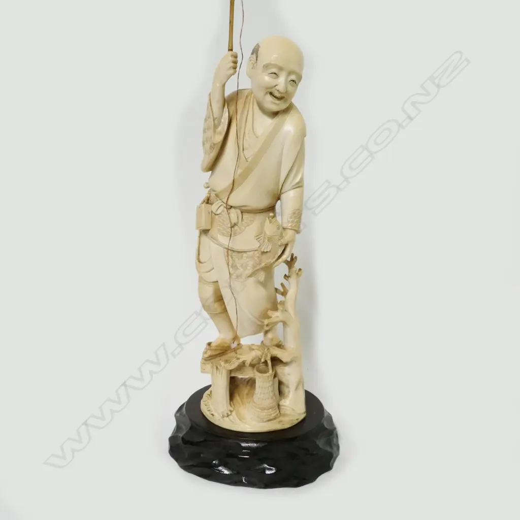 A Japanese ivory figure of a fisherman Image 1++