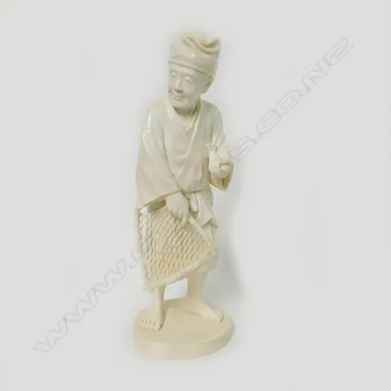 A Japanese carved ivory figure of a fisherman
