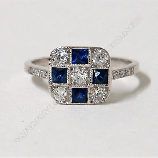 A lady's 18ct. Art Deco style diamond and sapphire cluster ring