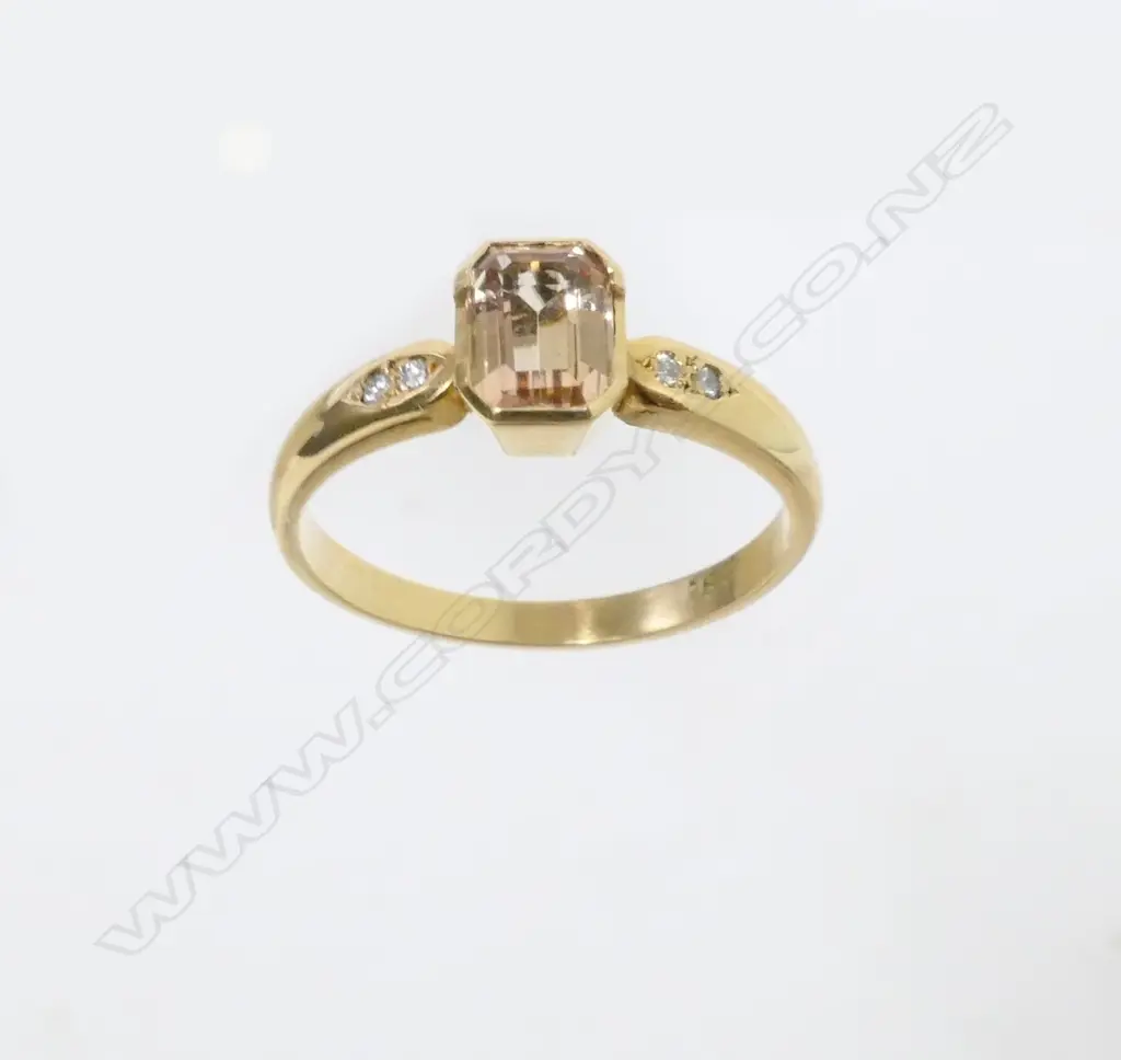 An 18ct. gold topaz and diamond ring Image 1++