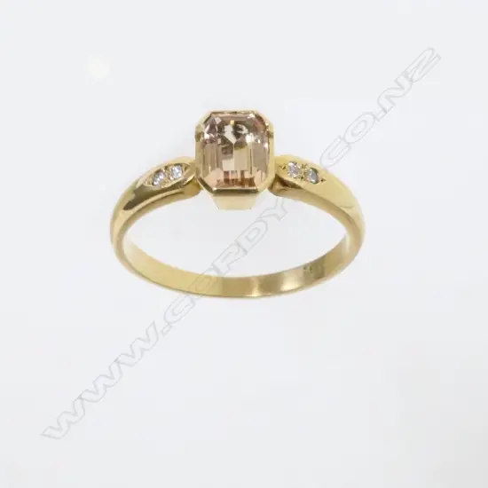 An 18ct. gold topaz and diamond ring