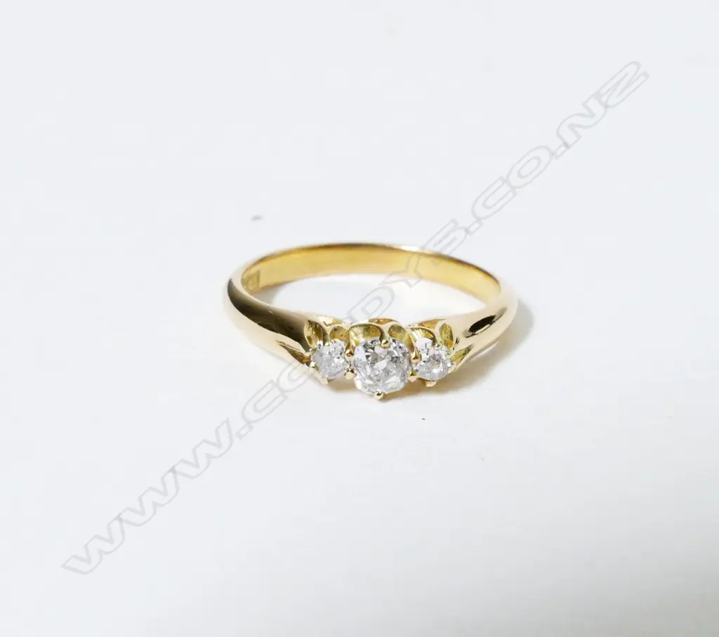An 18ct. gold and three stone diamond ring Image 1++