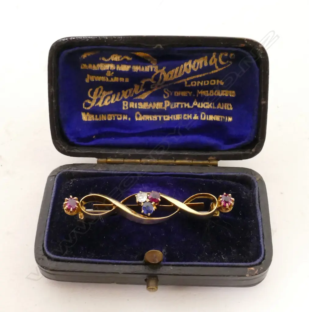 An 18ct. yellow gold ruby diamond and sapphire brooch Image 1++