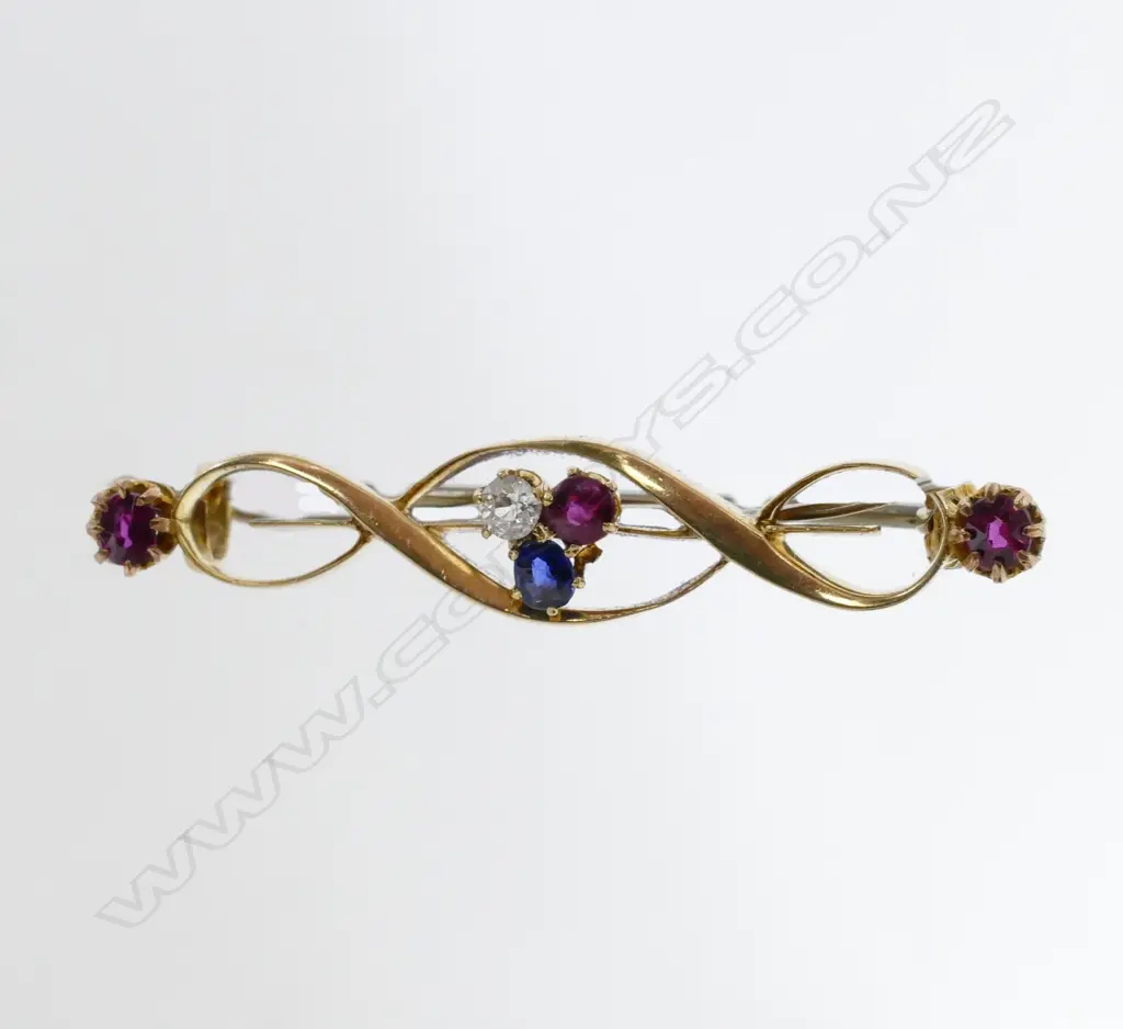 An 18ct. yellow gold ruby diamond and sapphire brooch Image 1++