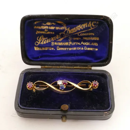 An 18ct. yellow gold ruby diamond and sapphire brooch