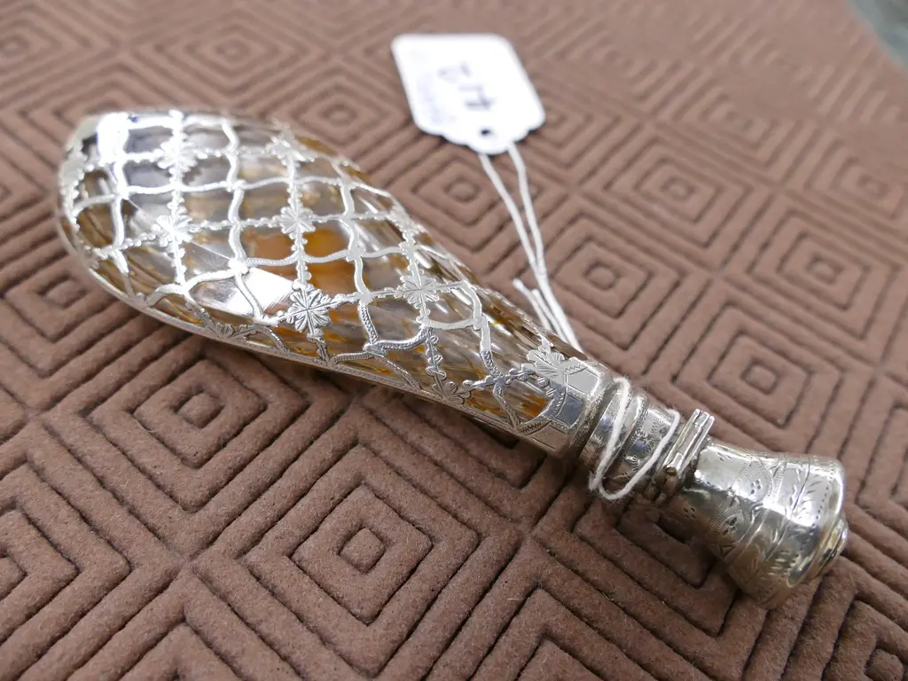 A late 19thC European silver covered glass scent bottle Image 1++