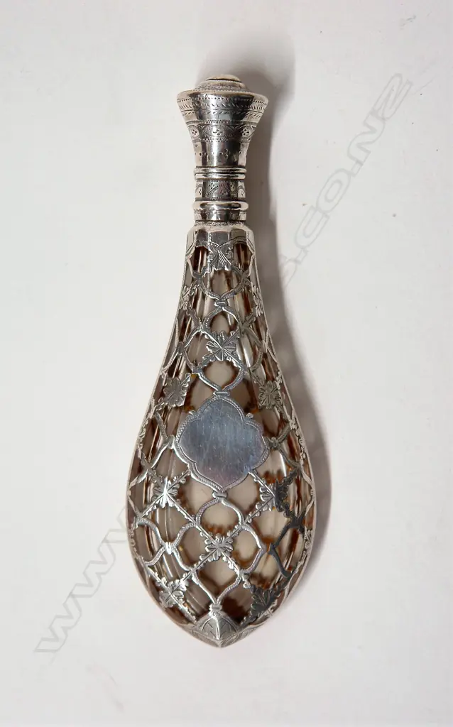 A late 19thC European silver covered glass scent bottle Image 1++