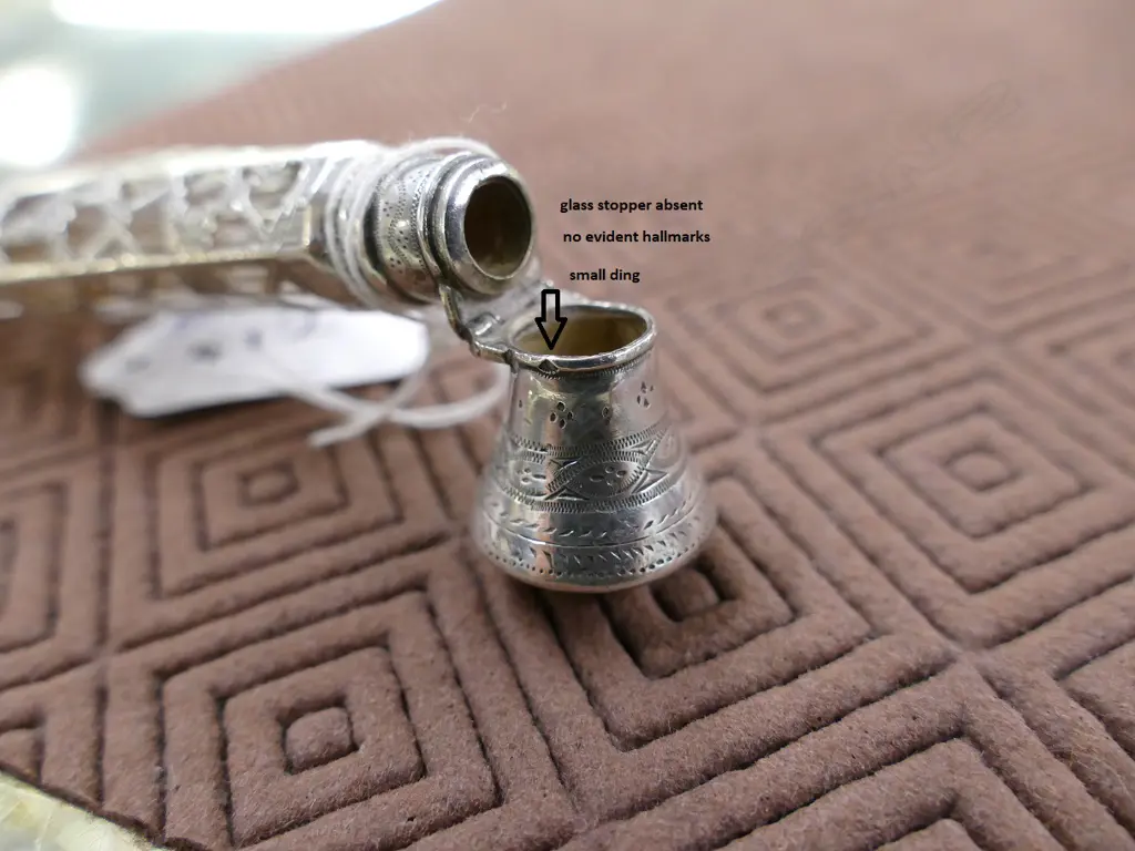 A late 19thC European silver covered glass scent bottle Image 1++