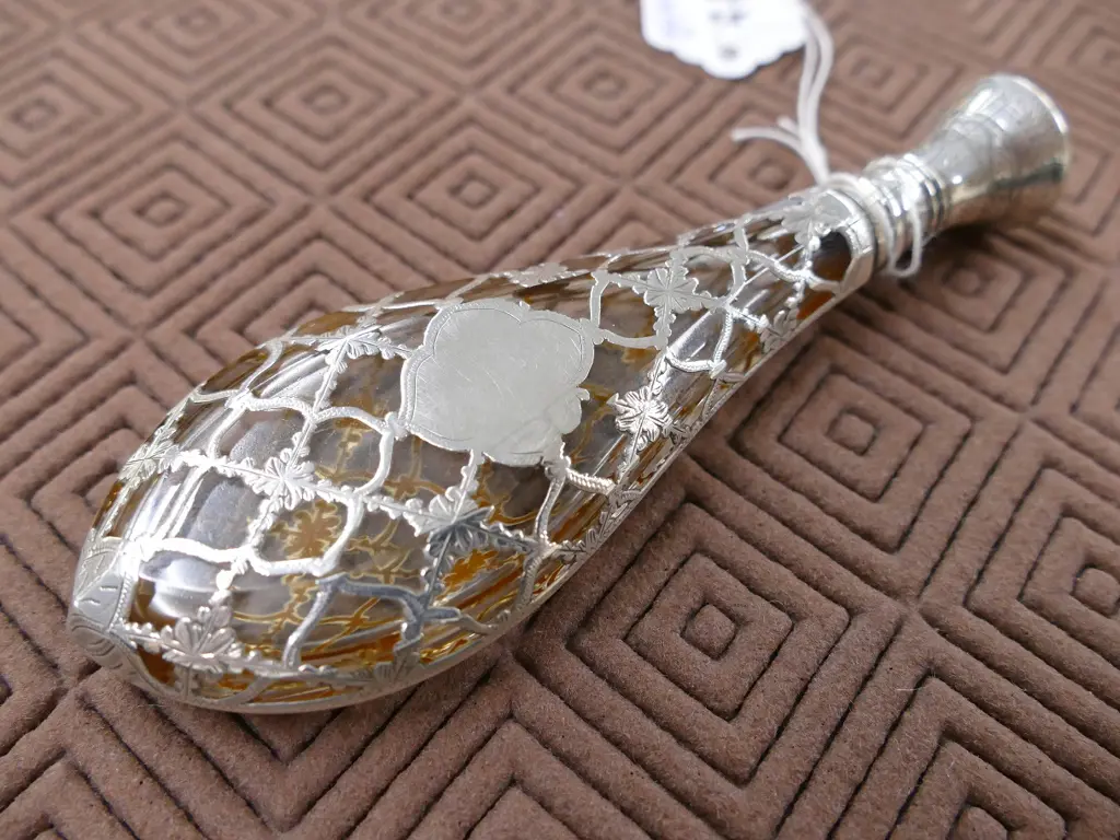 A late 19thC European silver covered glass scent bottle Image 1++