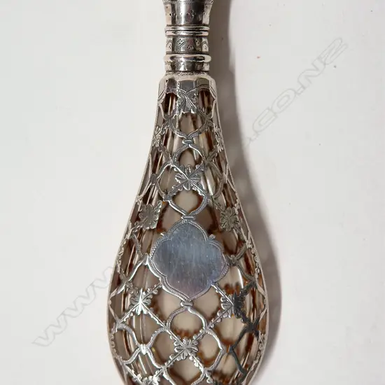 A late 19thC European silver covered glass scent bottle