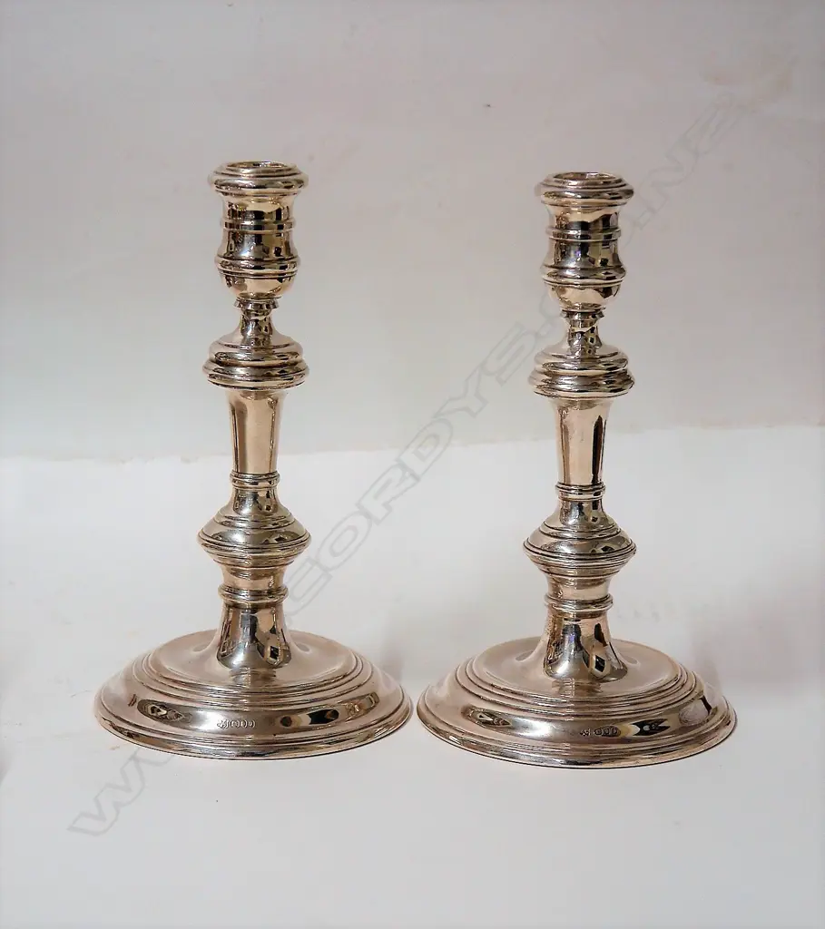 A pair of cast Georgian style silver column candlesticks Image 1++