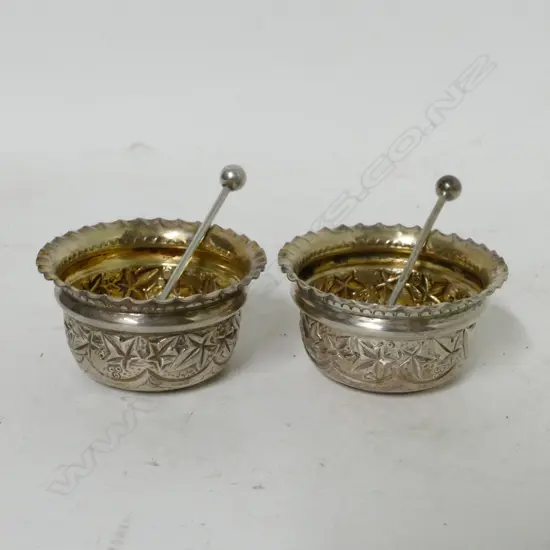A pair of Edwardian embossed circular silver salts