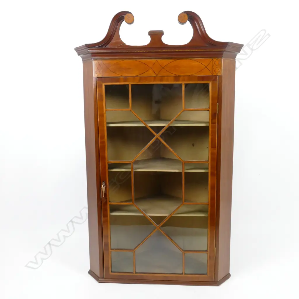 A Georgian mahogany hanging corner cabinet with an astragal glazed door Image 1++