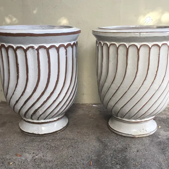 A pair of very large white glazed garden urns