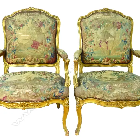 A pair of old French giltwood framed fauteuils upholstered in good tapestries