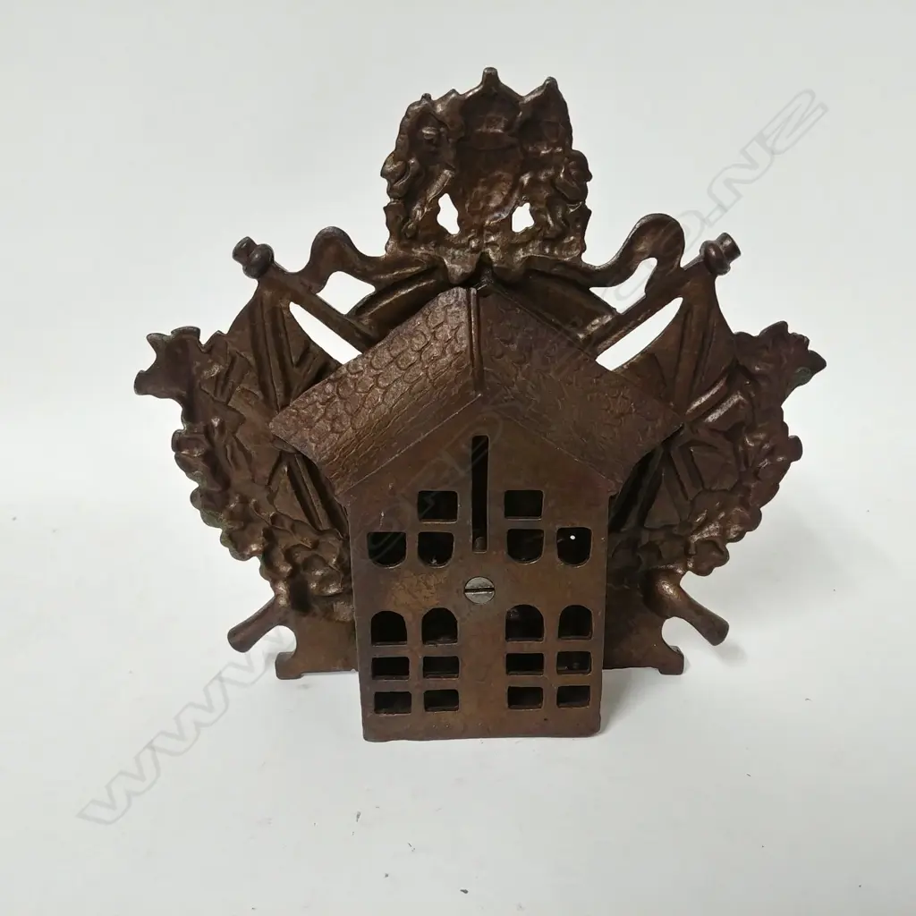 A vintage cast iron money bank Image 1++