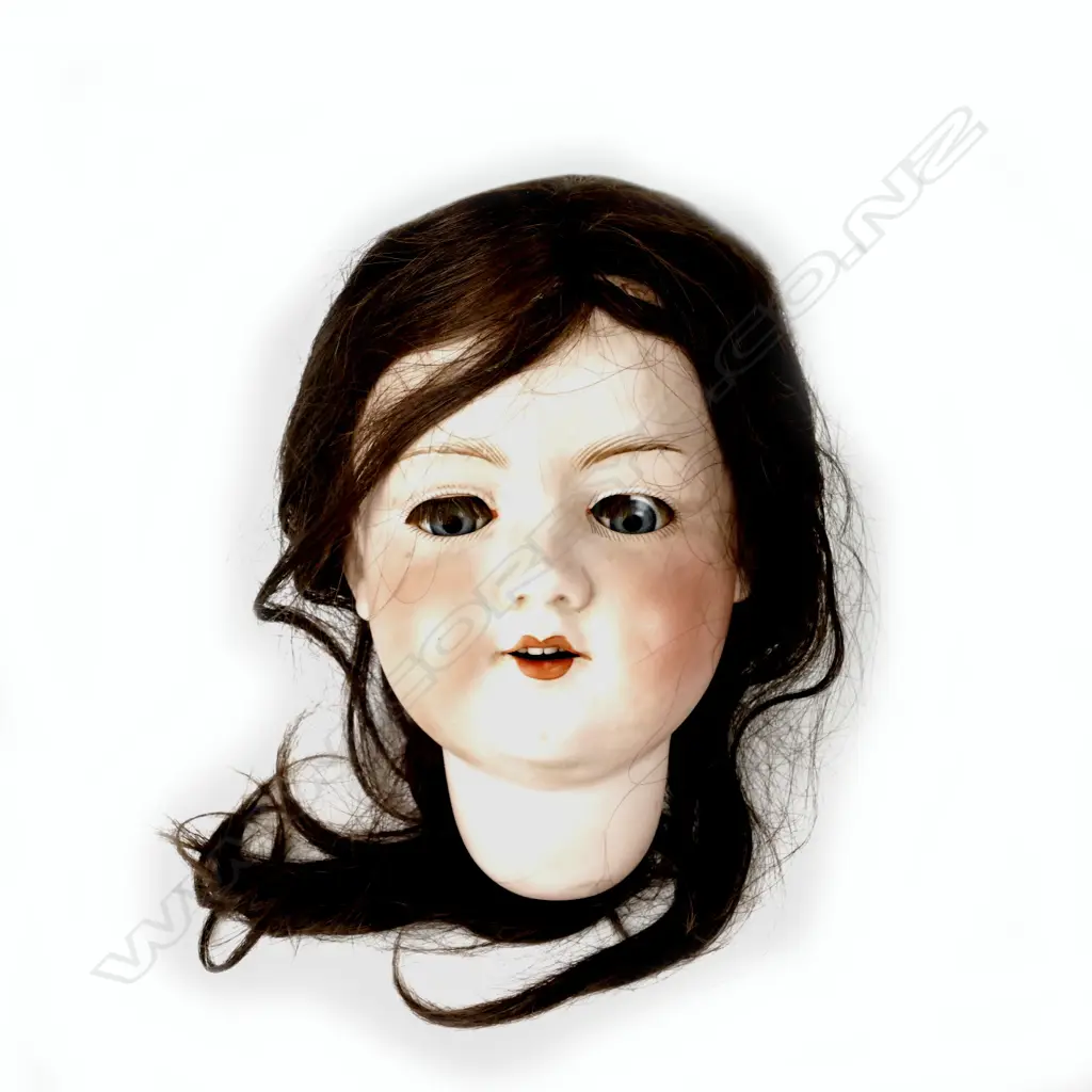 The bisque head of an Armand Marseille doll with sleeping blue glass paperweight eyes Image 1++
