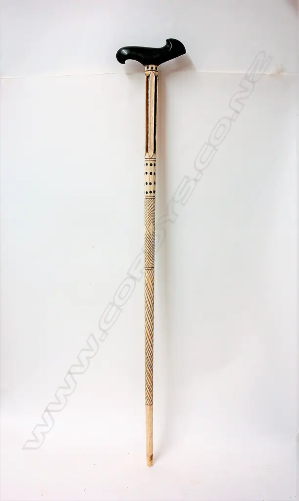 A 19thC decorated whalebone walking stick with later sculpted greenstone handle Image 1++