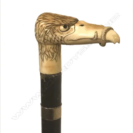 A carved marine ivory eagle head walking stick