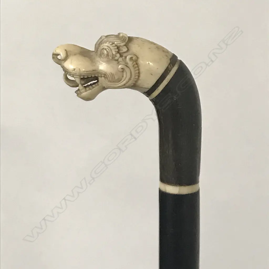 A walking cane with stylised S.E. Asian dragon head finial Image 1++