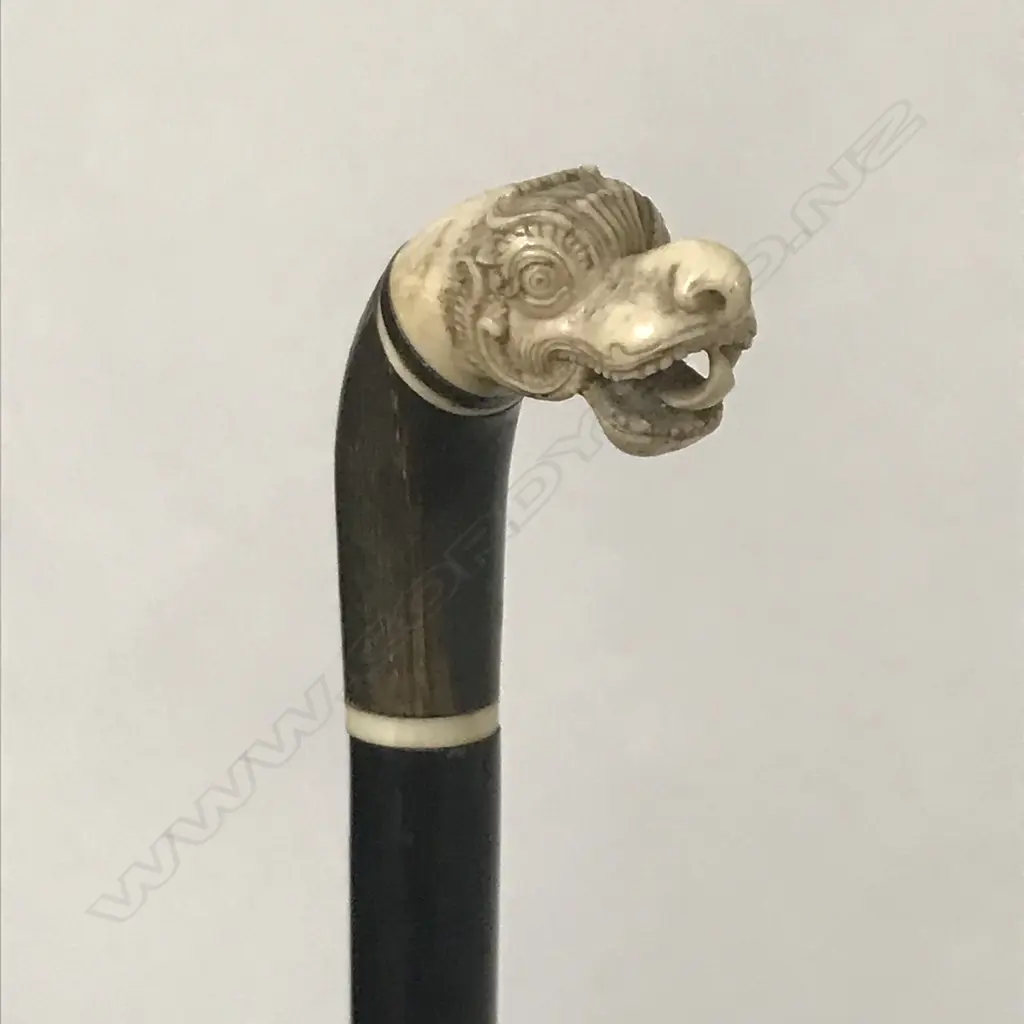 A walking cane with stylised S.E. Asian dragon head finial Image 1++