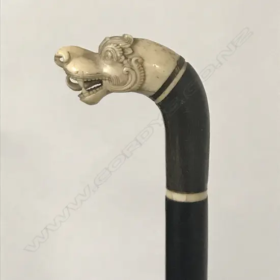 A walking cane with stylised S.E. Asian dragon head finial