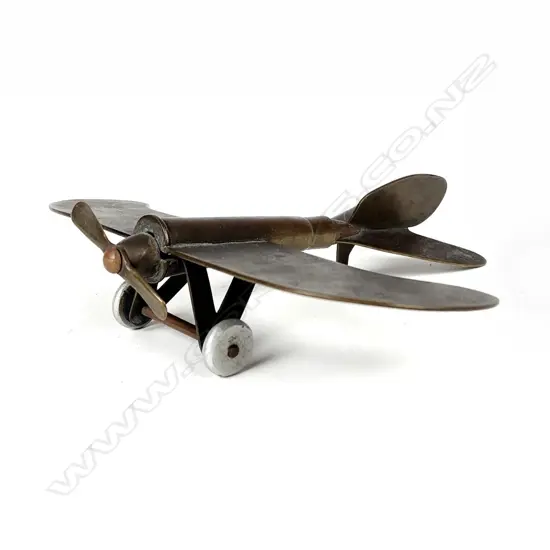 A small rare trench art model of a fixed wing propeller driven model aeroplane