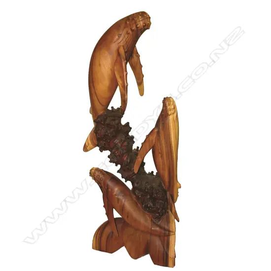 A Tasmanian blackwood carving of three leaping humpback whales by Brian Webb (N.Z.)