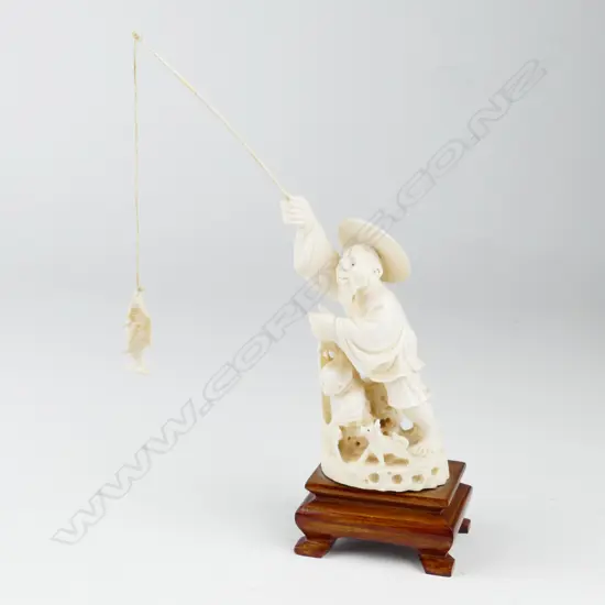 A Chinese carved ivory fisherman