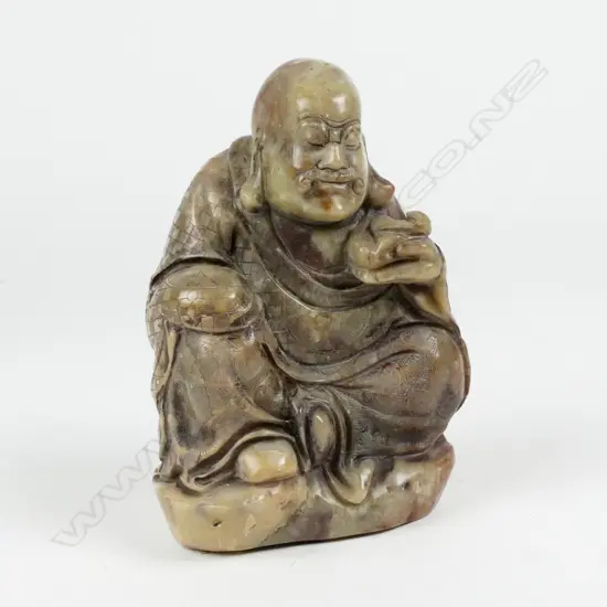 A carved hard stone statue of a seated Bodhisattva