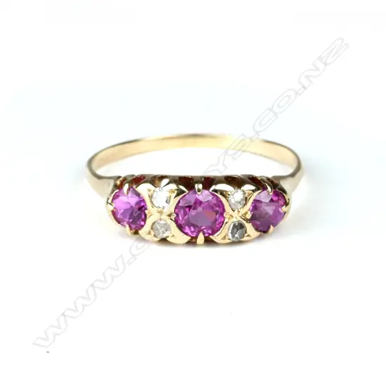 An 18ct. yellow gold estate diamond and pink sapphire bridge ring