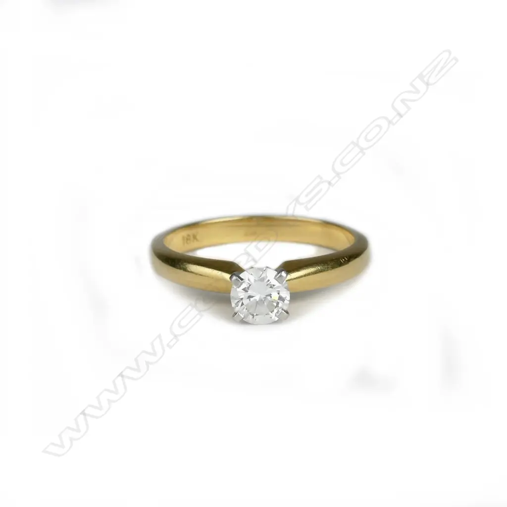 An 18ct. gold and diamond solitaire ring Image 1++