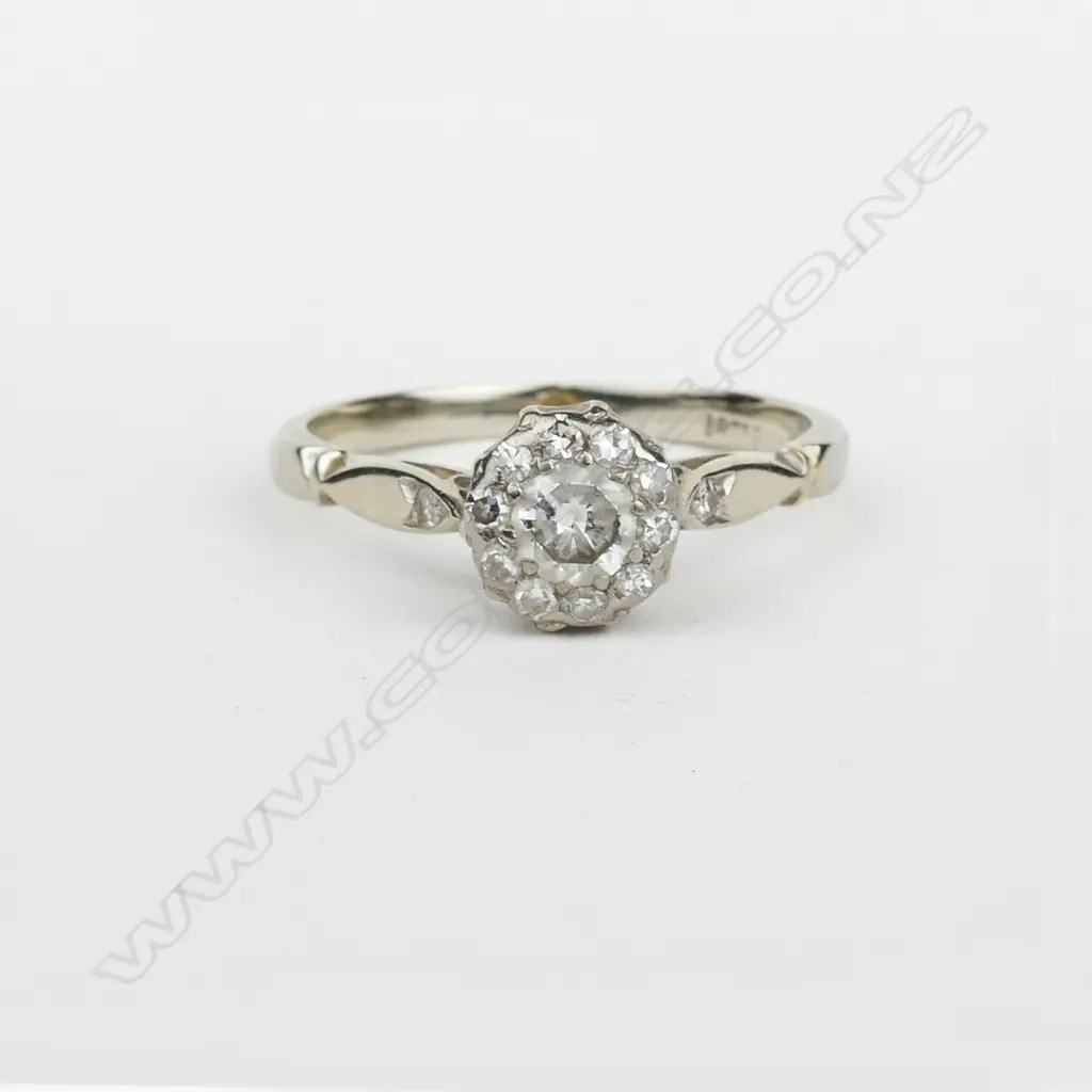 An early 20thC 18ct. white gold and diamond dress ring Image 1++