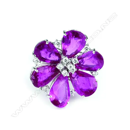 An 18ct gold white gold rubelite and diamond dress ring