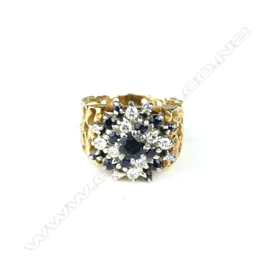 An 18ct. gold diamond and sapphire dress ring