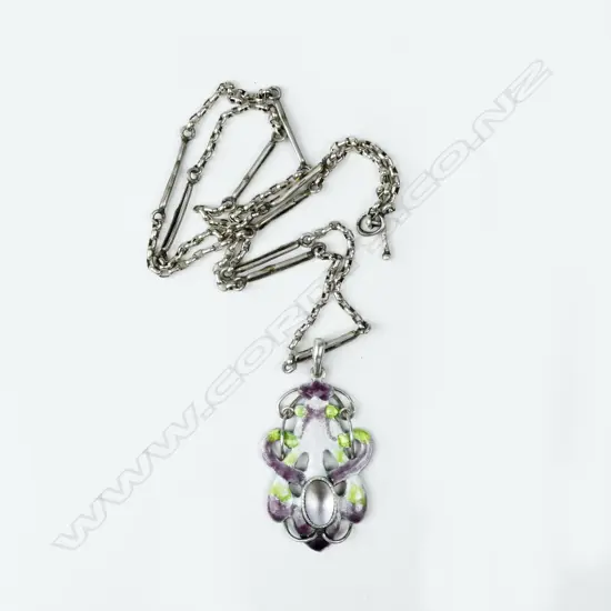 An interesting New Zealand Arts & Crafts silver enamel and m-o-p 'suffragist' pendant