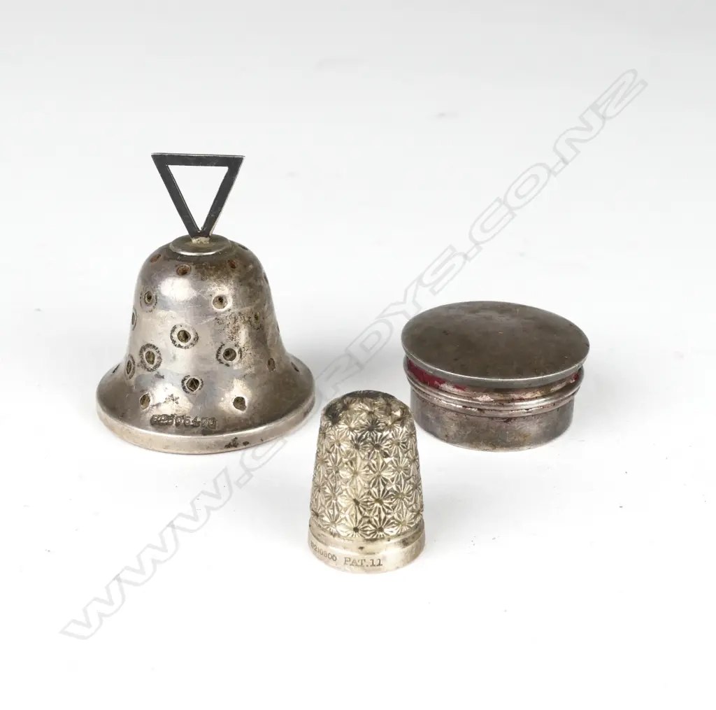 A silver bell shaped pin cushion Image 1++