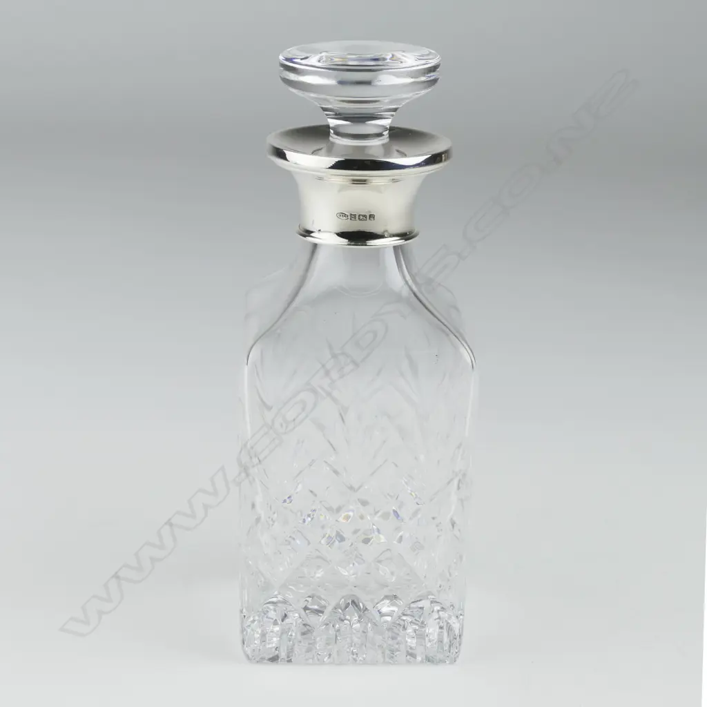 A modern silver and glass perfume bottle Image 1++