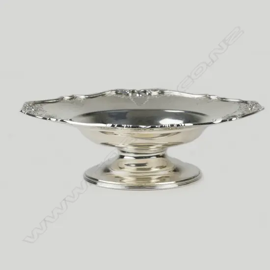 A shallow silver dish on stand