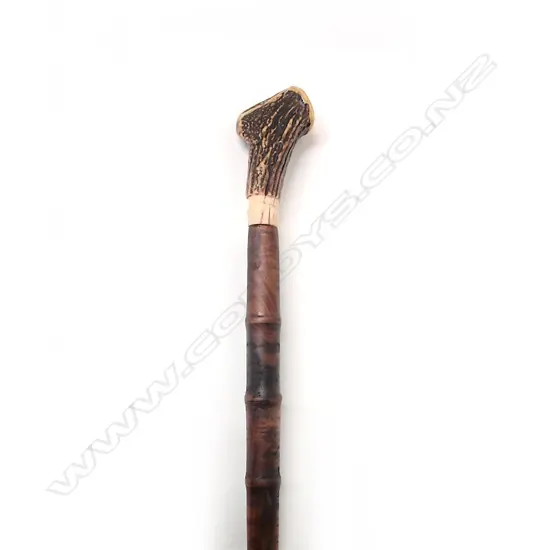 A walnut and antler handled walking stick